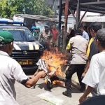 Terduga pelaku kini dirawat di RS Bhayangkara setelah mengalami luka bakar serius. Polisi mengimbau warga tidak main hakim sendiri.